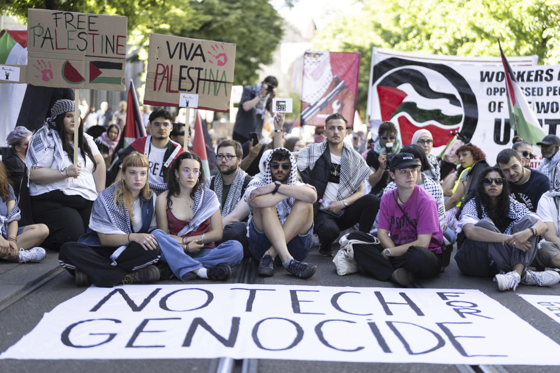 Participants sit in silence and wave Palestinian flags during a demonstration organized to mark 'Nakba Day' under the slogan 'Stop the genocide in Gaza' in Zurich, Switzerland, Saturday, May 11, 2024. (AP)