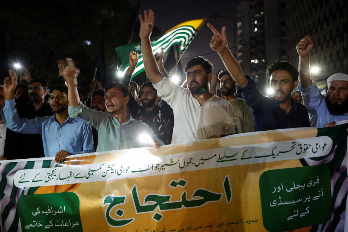 People hold a banner as they chant slogans in support of an alliance of civil rights groups protesting in Pakistan-ruled Kashmir, demanding the government give the region a subsidy on electricity and wheat prices in the face of rising inflation, during a demonstration in Karachi, Pakistan May 13, 2024. REUTERS/Akhtar Soomro