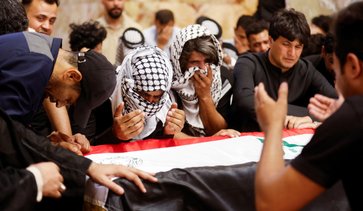 Mourners react near the coffin of an Iraqi soldier, who was killed in an attack by Daesh militants on an army post in a rural area between Diyala and Salahuddin provinces, during the funeral in Najaf, Iraq, May 14, 2024. (REUTERS)