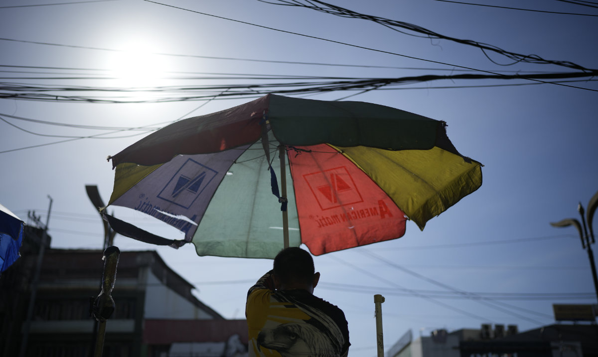 A vendor prepares his umbrella as hot days continue in Manila, Philippines on April 29, 2024. Sizzling heat across Asia and the Middle East in late April that echoed last year destructive swelter was made 45 times more likely in some parts of the continent because of human-caused climate change, a study found. (AP/File)