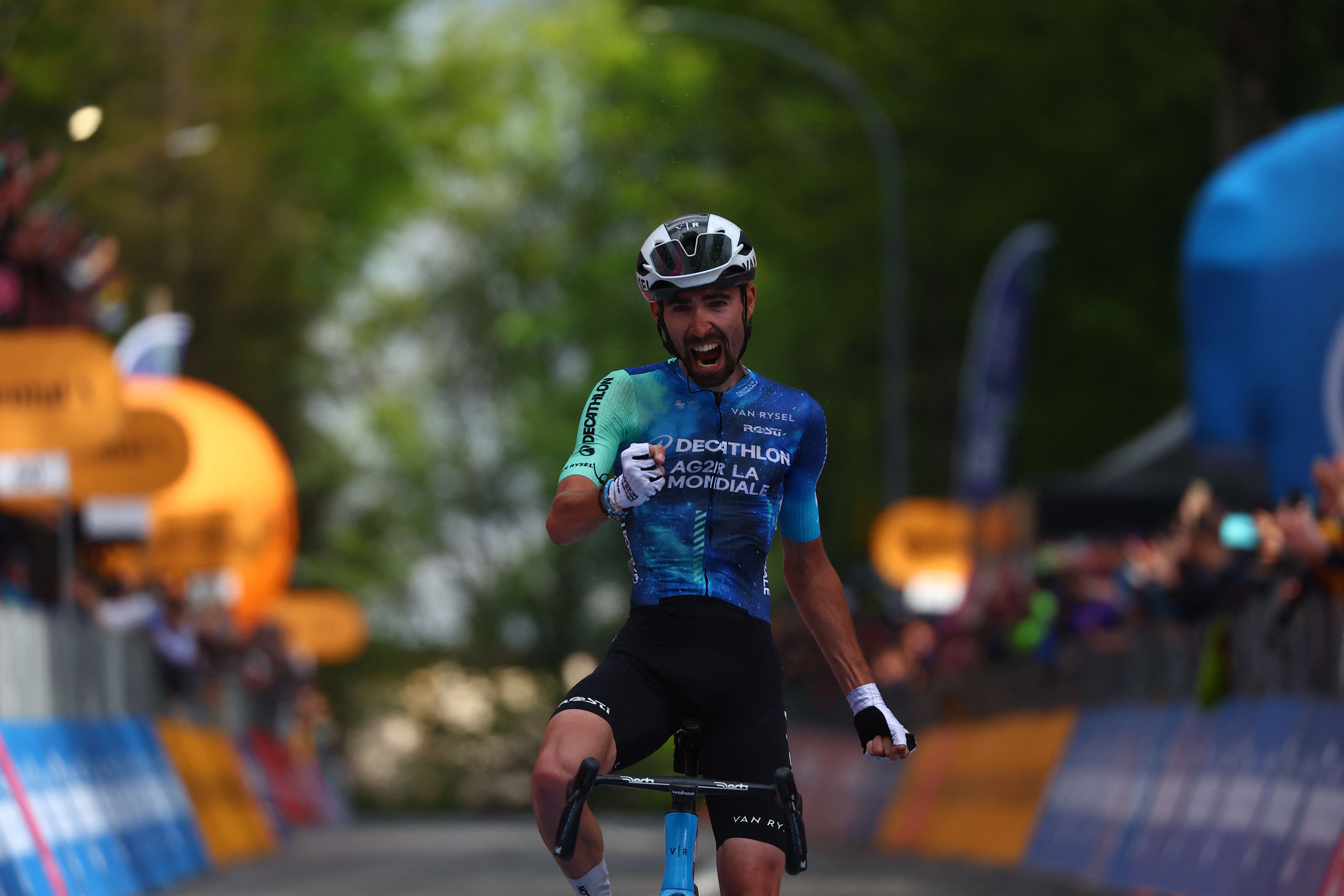 Team Decathlon AG2R's French rider Valentin Paret-Peintre celebrates as he crosses the finish line to win the 10th stage of the 107th Giro d'Italia cycling race, 142km between Pompei and Cusano Mutri (Bocca della Selva) (AFP)
