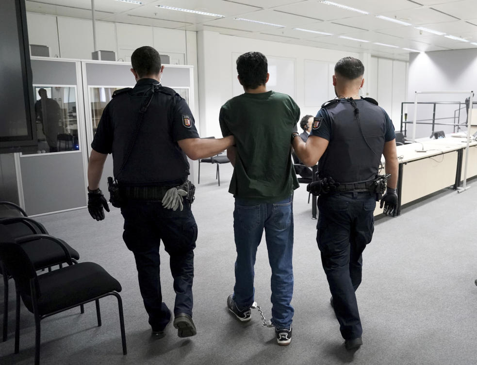 The defendant Ibrahim A. is brought into the courtroom in handcuffs, in Itzehoe, Germany.(AP)