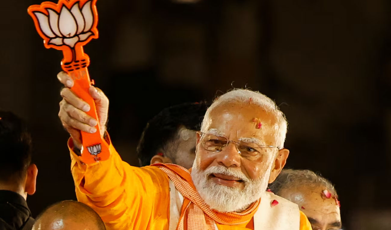 India’s Prime Minister Narendra Modi shows the Bharatiya Janata Party (BJP) symbol during a roadshow as part of an election campaign, in Varanasi, India, May 13, 2024. (REUTERS)