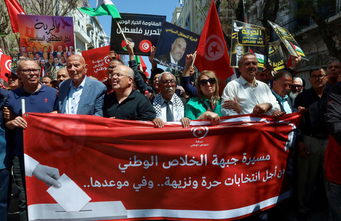 FILE PHOTO: Imed Khemiri, a senior official in the Ennahda party and member of the Salvation Front (L) takes part in a protest, demanding the release of imprisoned journalists, activists, opposition figures and setting a date for fair presidential elections in Tunis. (REUTERS)