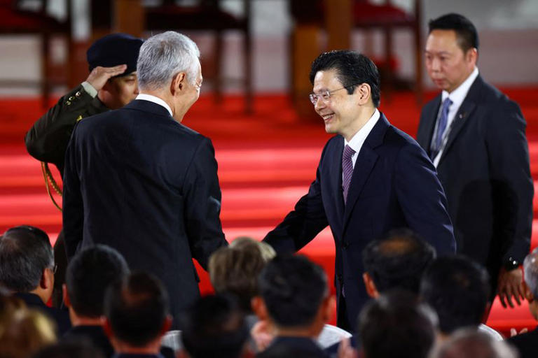 Singapore's new Prime Minister Lawrence Wong shakes hands with the country's third PM Lee Hsien Loong on the day he is sworn in as Singapore's fourth premier at the Istana, in Singapore. (File/Reuters)