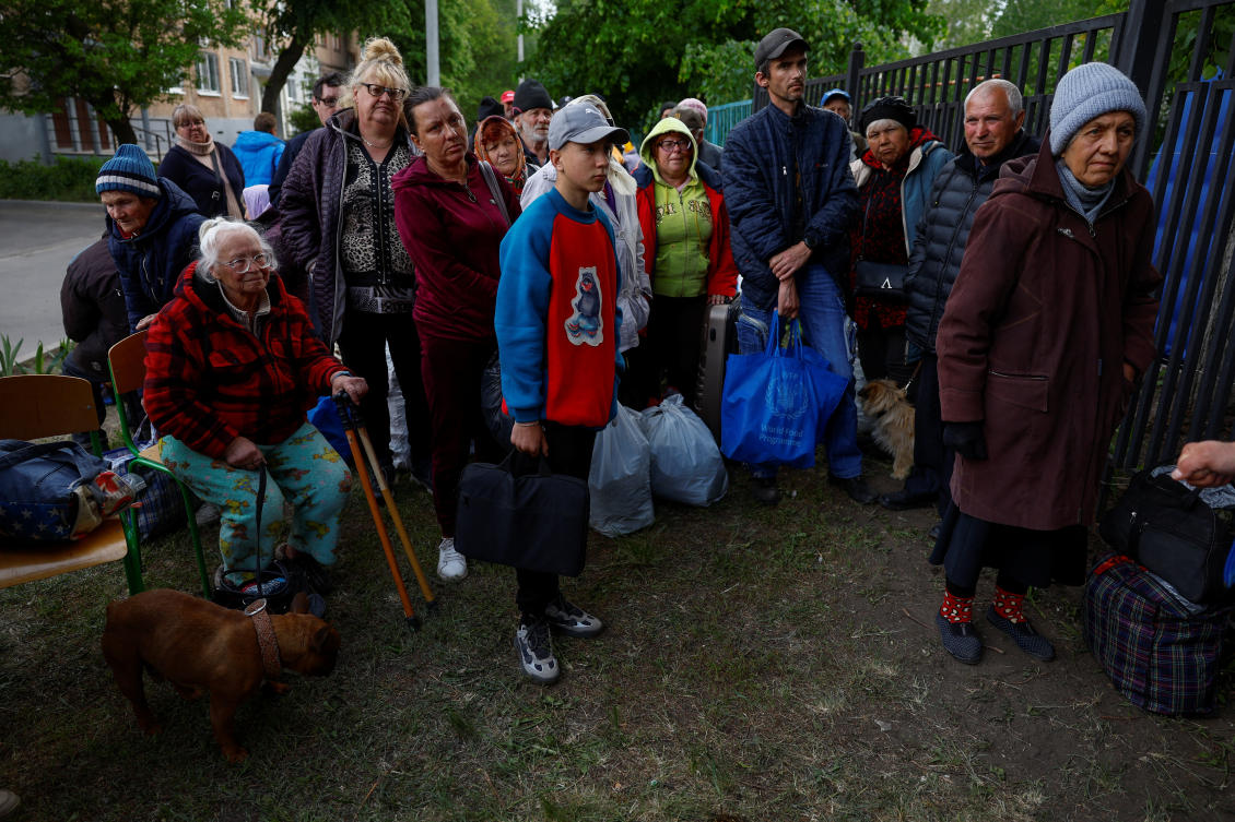 Vovchansk area residents, who fled due to Russian military strikes, gather at an evacuation center compound in Kharkiv region on May 14, 2024. (Reuters)
