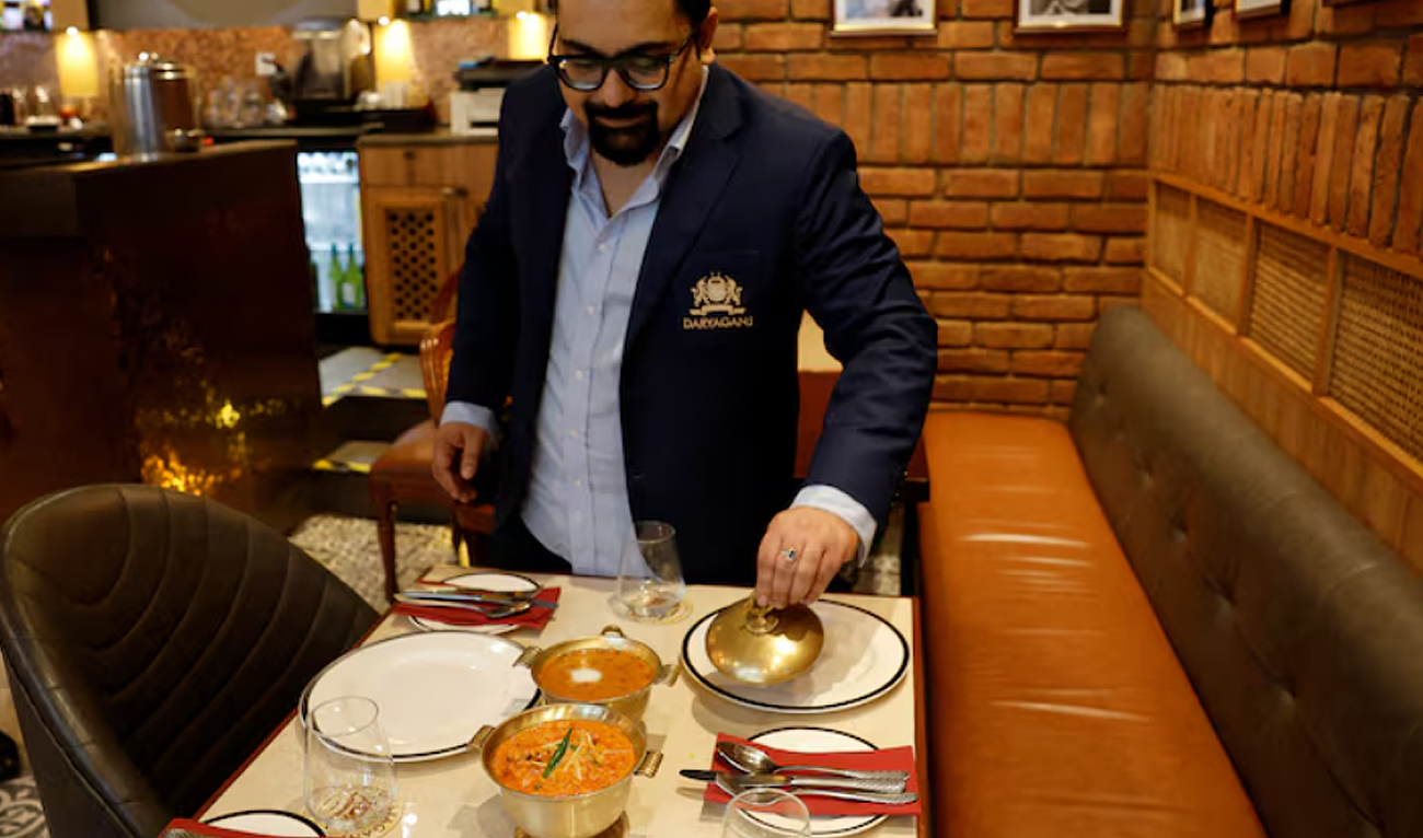 Amit Bagga, CEO of Daryaganj restaurant, shows a freshly prepared butter chicken dish and the lentil dish Dal Makhani inside Daryaganj restaurant at a mall, in Noida, India, January 23, 2024. (REUTERS/File)