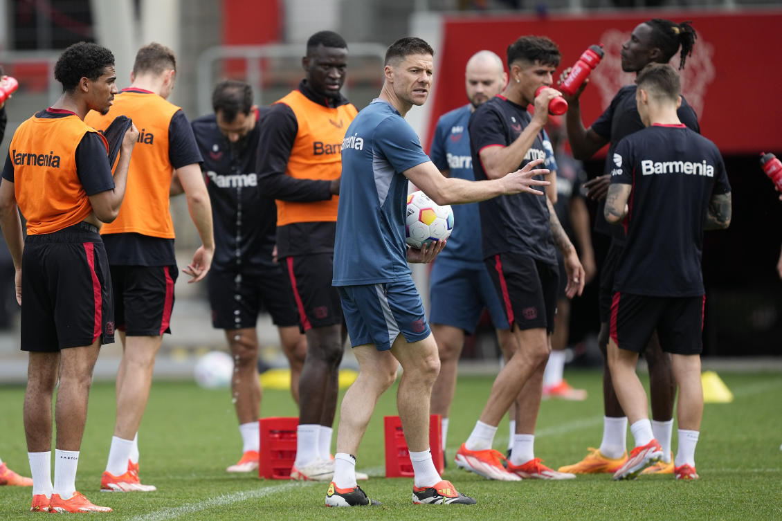 Bayer Leverkusen’s head coach Xabi Alonso talks to his players during a training session at a media day in Leverkusen on May 15, 2024. (AP)