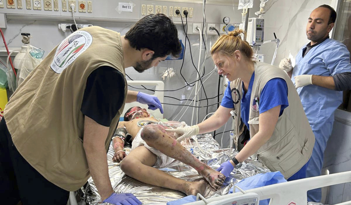 Monica Johnston RN, Burn and wound care nurse from Portland Oregon with the PAMA Palestinian American Medical Association, monitors a patient who sustained major burns on May 8, 2024, Khan Younis, Gaza. (AP)