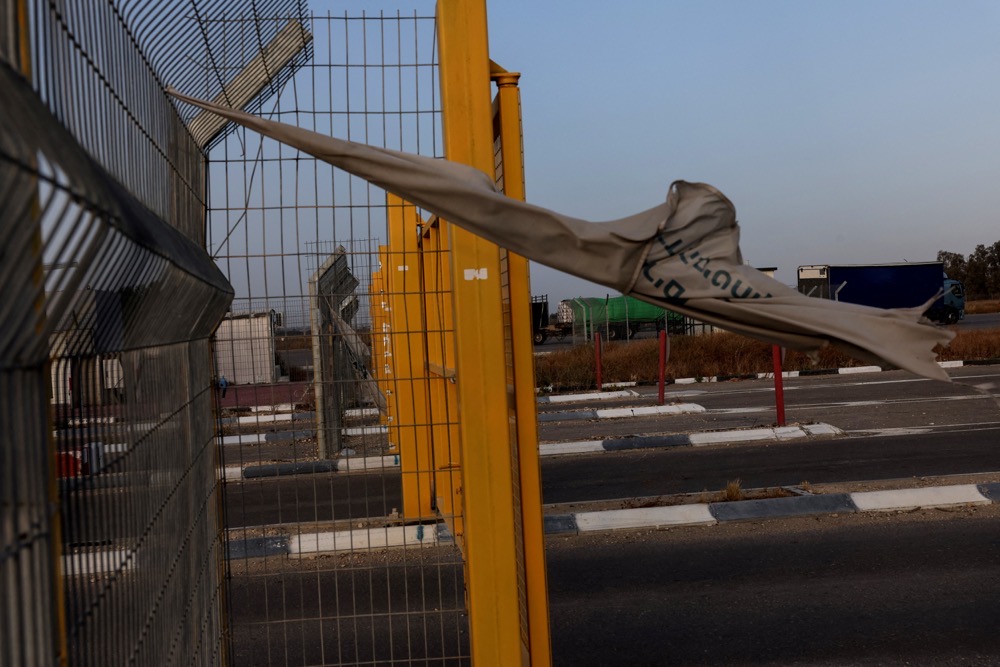 Food aid trucks sit abandoned near the entrance to the Kerem Shalom border crossing, as military operations continue in the southern Gaza city of Rafah. (Reuters)