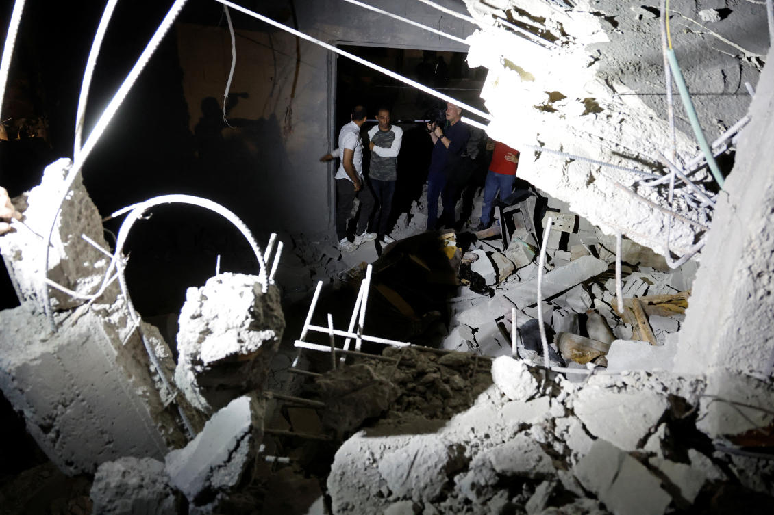 Palestinians inspect the site of an Israeli military airstrike, in the area of Jenin, in the Israeli-occupied West Bank. (Reuters)