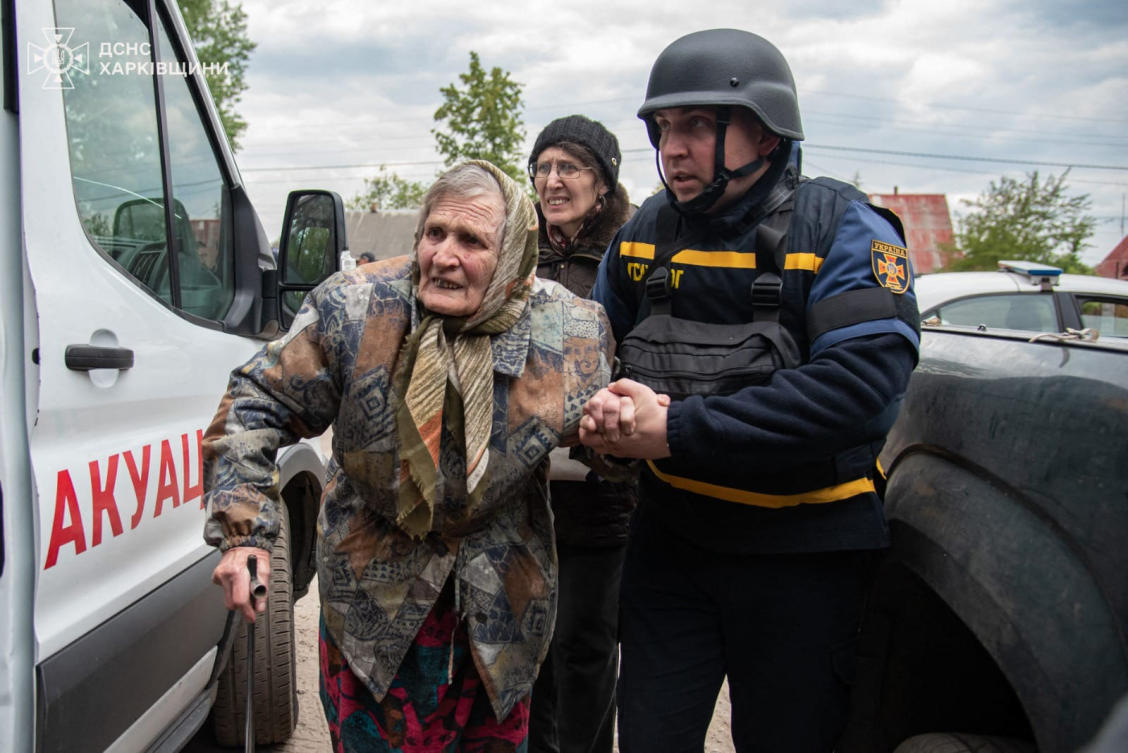 Rescuers evacuate an elderly civilian from Russian shelling in Kharkiv region on May 17, 2024. (Ukrainian Emergency Service via AFP)