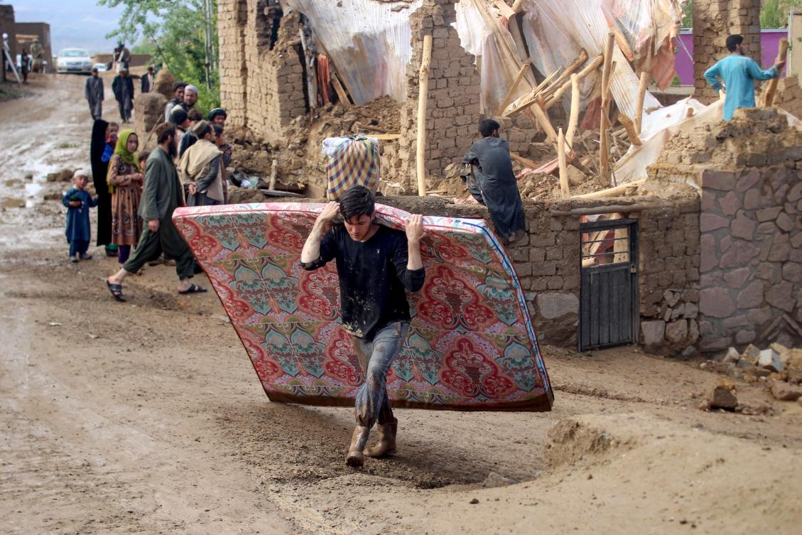 Thousands of homes and properties were damaged and hundreds of hectares of agricultural land destroyed following Friday’s floods. Above, residents clean debris and salvage their belongings after the flash floods in Firozkoh, Ghor province on May 18, 2024. (AFP)