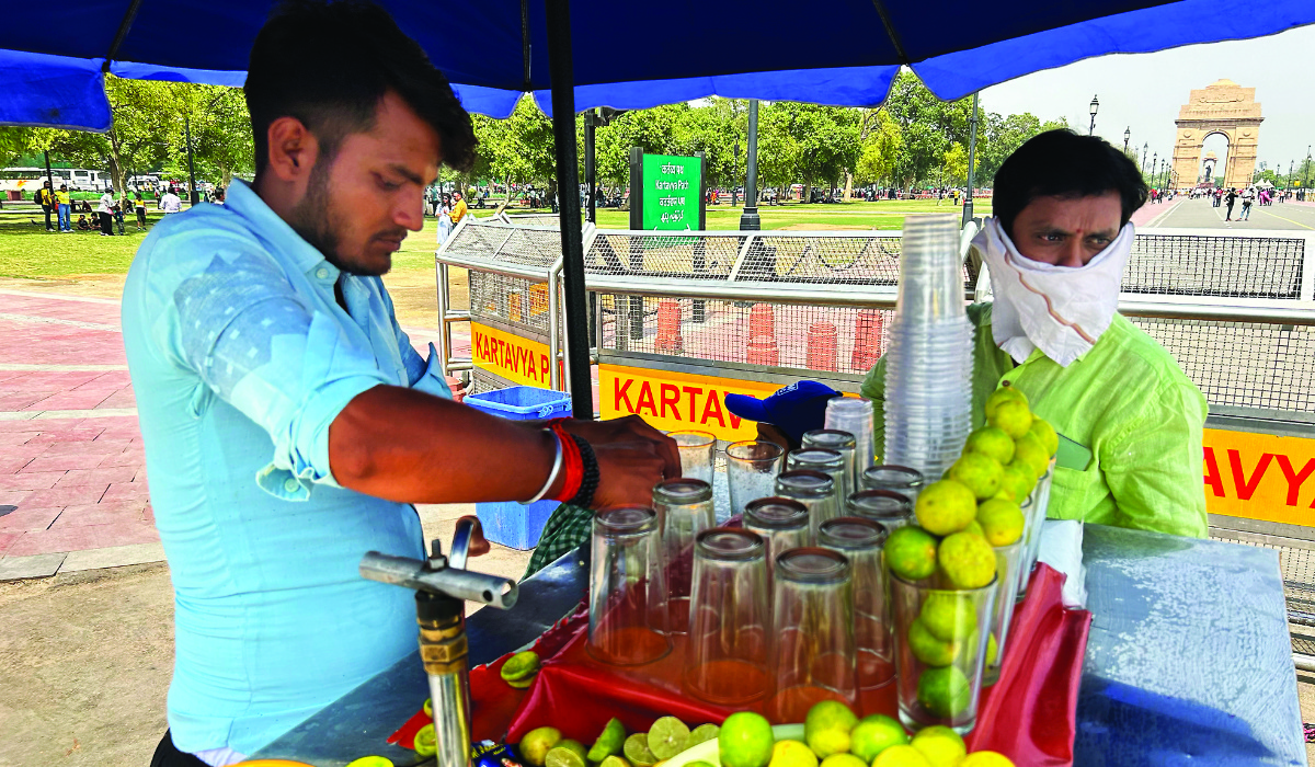 A roadside vendor sells iced lemonade in New Delhi, India, Saturday. (AP)