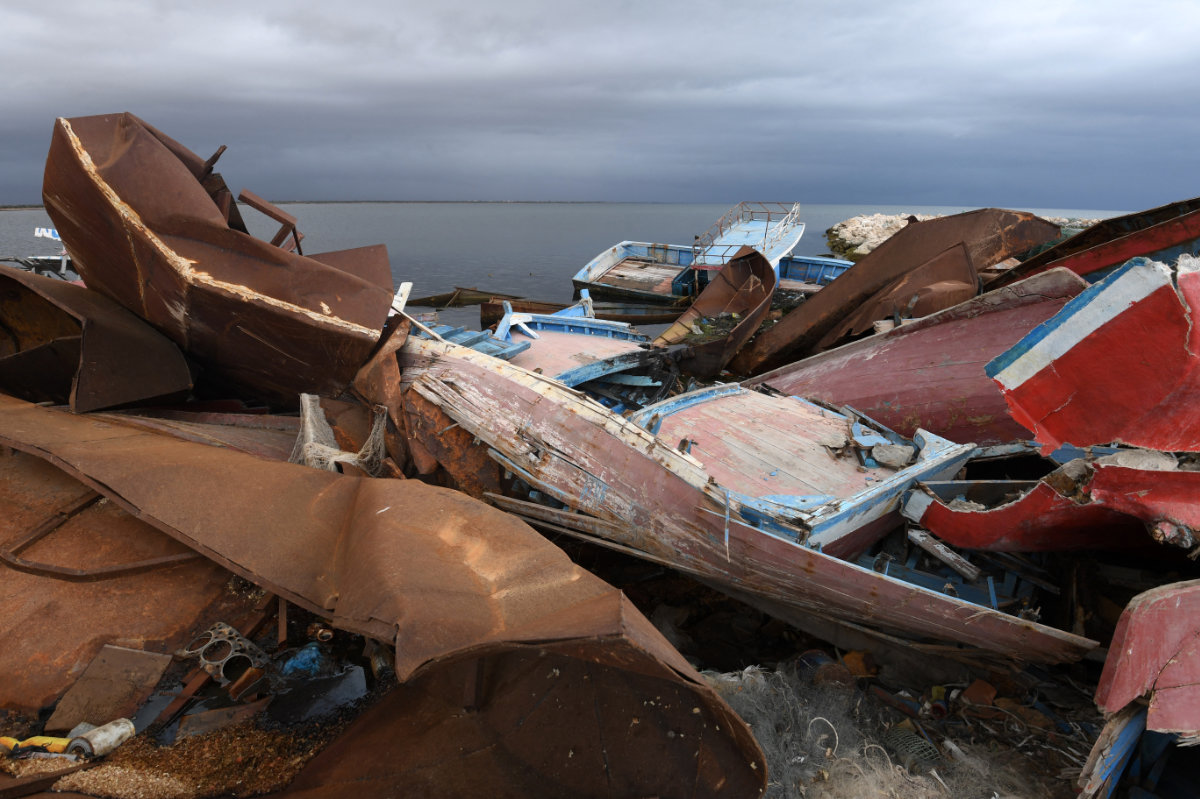 The remains of boats used by migrants to cross the Mediterranean to reach Europe are scattered along the port of El-Amra in Tunisia's Sfax governorate on April 24, 2024. (AFP)