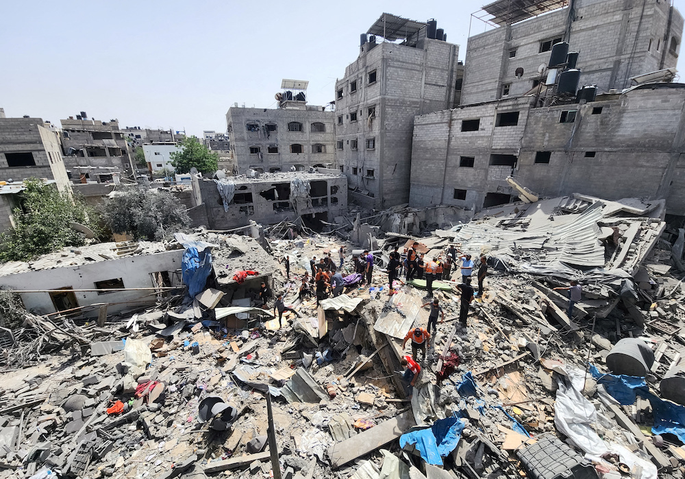 Palestinians carry the body of a person killed in an Israeli strike on a house in Jabalia refugee camp in the northern Gaza Strip on May 18, 2024. (Reuters)