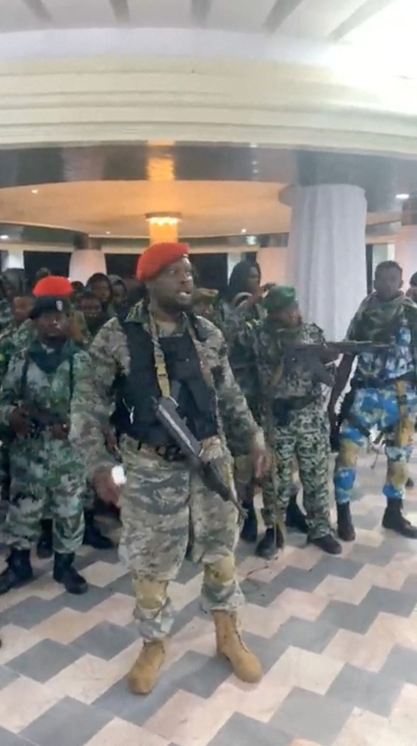 A man in military fatigues speaks as others stand next to him inside the Palace of the Nation during an attempted coup in Kinshasa, Democratic Republic of Congo, on May 19, 2024 in this screen grab from a social media video. (Christian Malanga/Handout via REUTERS)