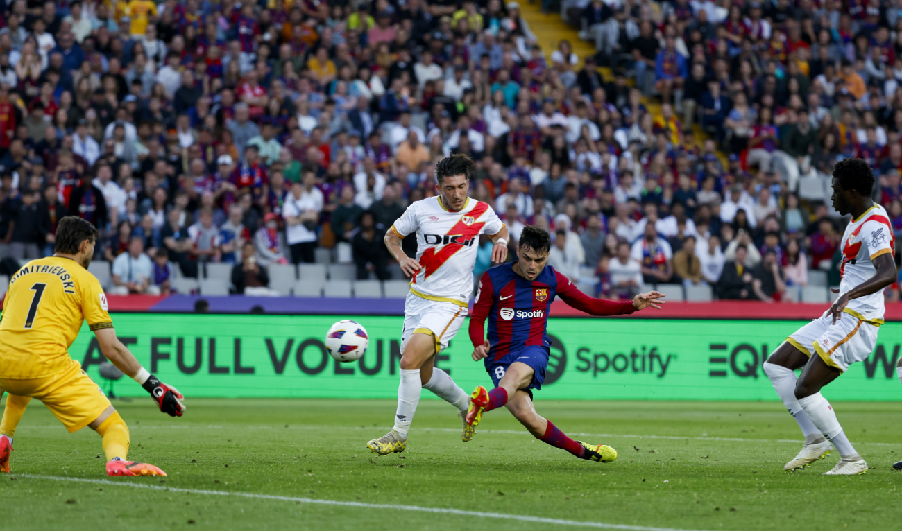Barcelona's Pedri, right, scores his side's third goal during a Spanish La Liga soccer match between Barcelona and Rayo Vallecano at the Olimpic Lluis Companys stadium in Barcelona Sunday. (AP)