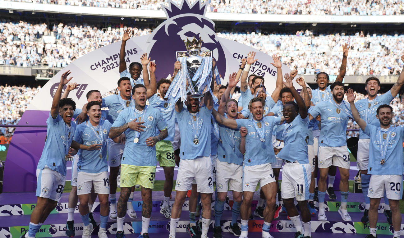Manchester City players celebrate with the Premier League trophy after the English Premier League match between Manchester City and West Ham United at the Etihad Stadium Sunday. (AP)