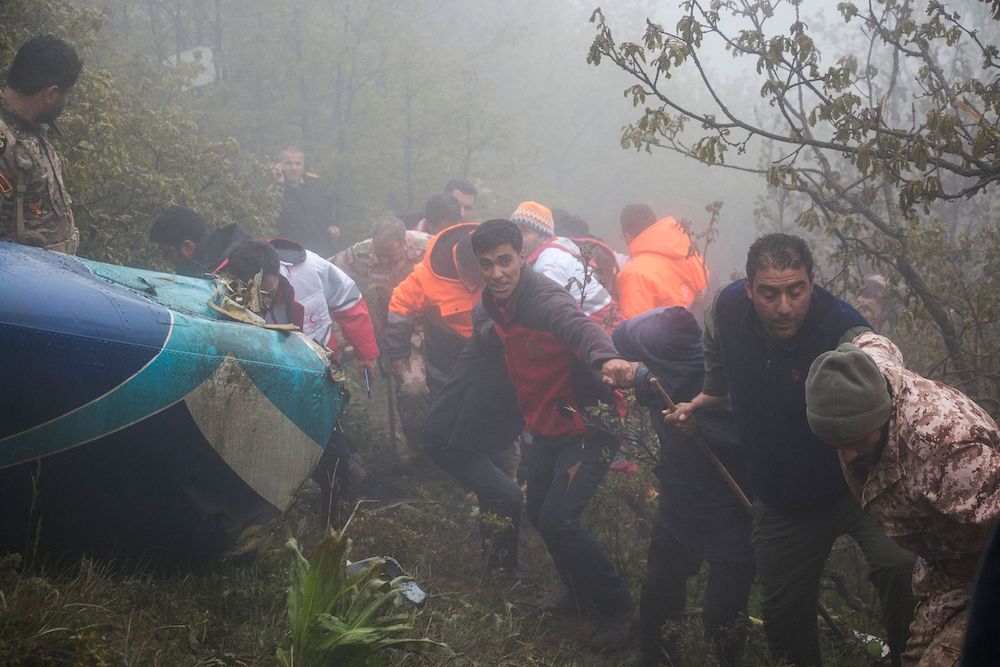 Rescue team members work at the crash site of a helicopter carrying Iranian President Ebrahim Raisi in Varzaghan, northwestern Iran on May 20, 2024. (MOJ News Agency/AFP)