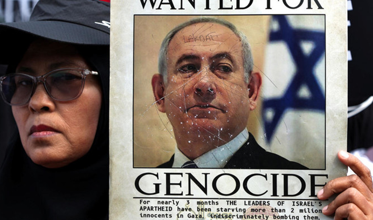 A Muslim activist looks on as she holds a placard depicting Israeli Prime Minister Benjamin Netanyahu during a protest against Israel and in support of Palestinians in Gaza, outside the U.S. embassy in Jakarta, Indonesia, May 17, 2024. (REUTERS/File)