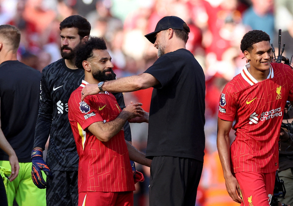 Juergen Klopp, right, celebrates with Mohamed Salah after his last match as Liverpool manager against the Wolverhampton Wanderers and his team won 2-0 on May 19, 2024. (Reuters)