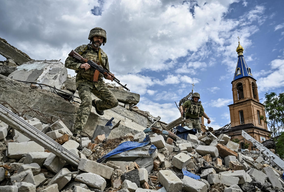 Ukrainian servicemen patrol an area heavily damaged by Russian military strikes in the town of Orikhiv in Zaporizhzhia region on May 20, 2024. (Reuters)