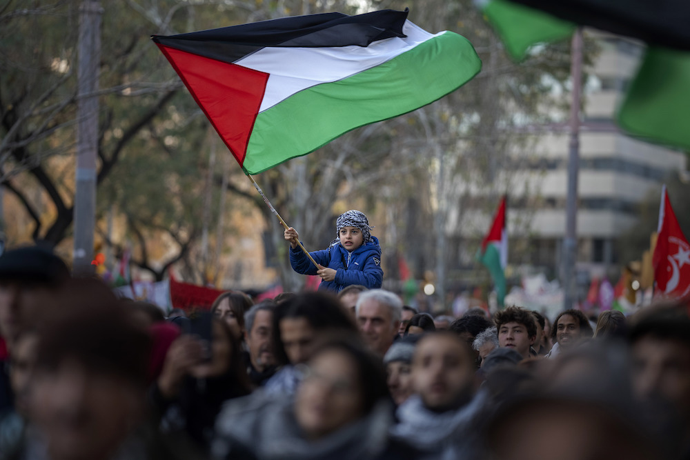 Above, a boy waves a Palestinian flag as demonstrators march during a protest in Barcelona on Jan. 20, 2024. Spain would recognize an independent Palestinian state on Tuesday May 28. (AP)