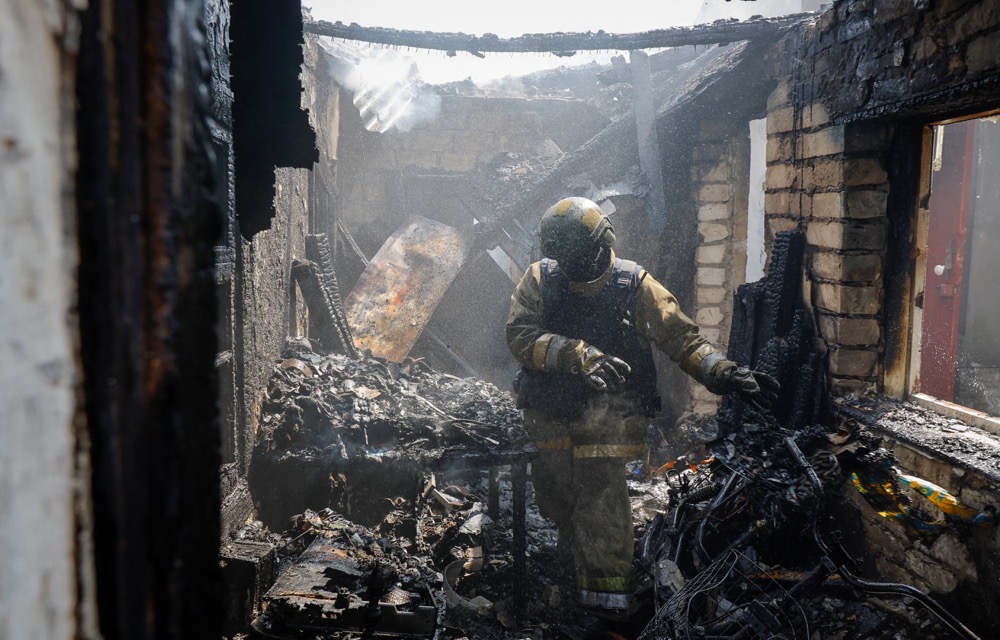 A firefighter works amid debris of a destroyed house in a residential area in Makiivka. (Reuters)