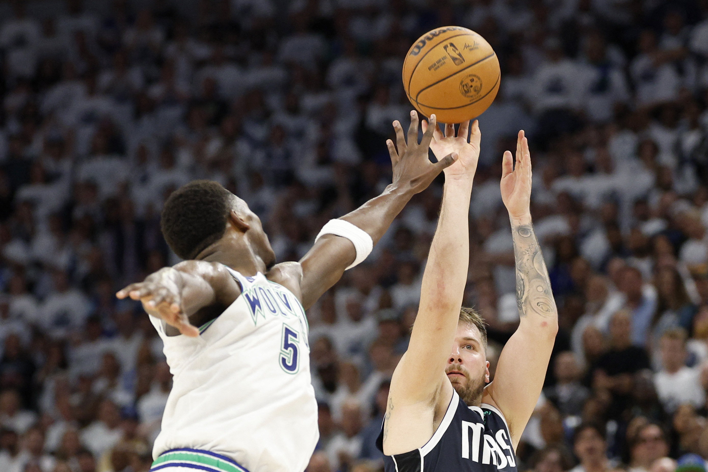 Luka Doncic of the Dallas Mavericks shoots the ball against Anthony Edwards of the Minnesota Timberwolves during the fourth quarter in Game 1 of the Western Conference Finals at Target Center on May 22, 2024 in Minneapolis, Minnesota. (GETTY IMAGES NORTH AMERICA /AFP)
