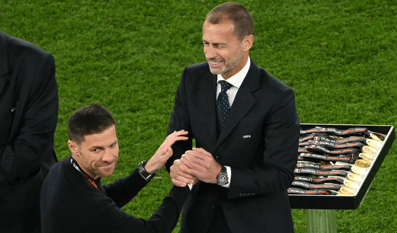 Bayer Leverkusen's Spanish head coach Xabi Alonso, left, with UEFA President Aleksander Ceferin after the UEFA Europa League final between Atalanta and Bayer Leverkusen at the Dublin Arena stadium, in Dublin, on May 22, 2024. Atalanta won 3-0. (AFP)