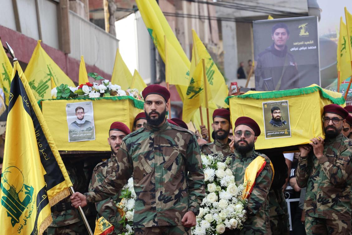 Mourners carry the coffins of two Hezbollah militants killed in an Israeli strike in southern Lebanon, during their funeral earlier this month in a south Beirut suburb. (File/AFP)