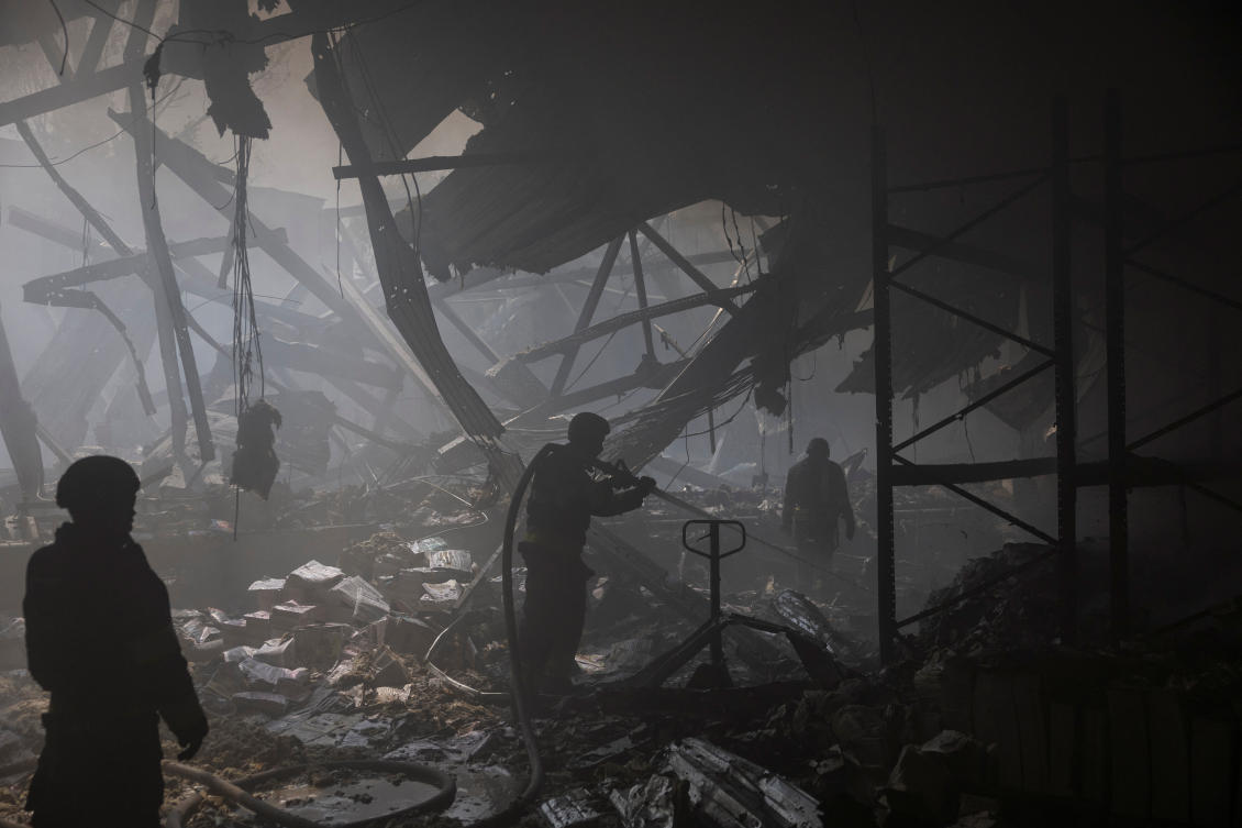Firefighters work at the site where a printworks was hit by Russian missile strikes in Kharkiv on May 23, 2024. (Reuters)