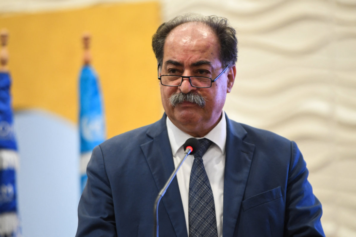Tunisian Interior Minister Kamel Al-Feki, shown in this photo speakoing during the Arab Forum to curb migrant smuggling on May 21, 2024, was fired by President Kais Saied on Saturday. (AFP)