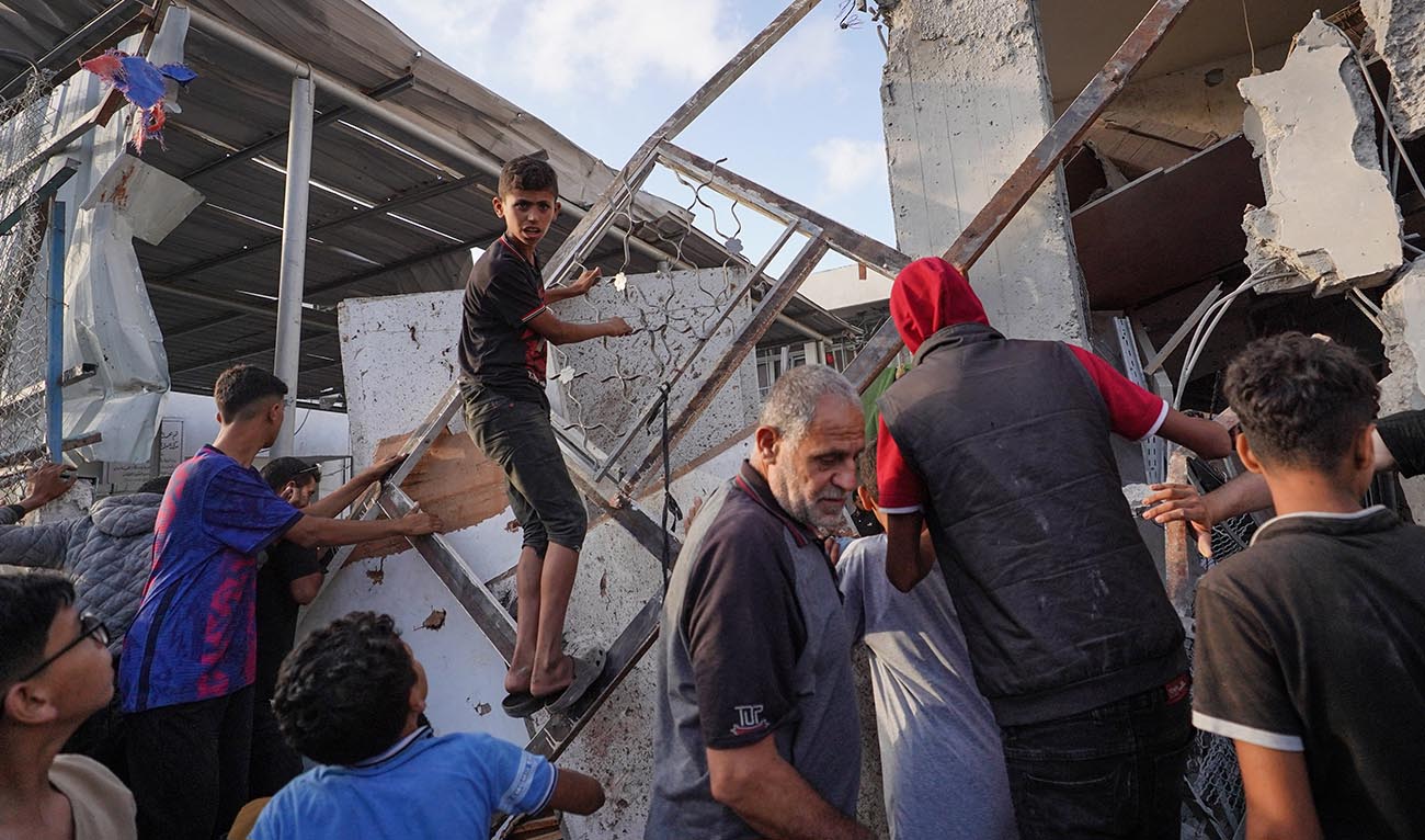 Palestinians inspect the aftermath of an Israeli strike on a building in Nuseirat on May 25, 2024, amid continuing battles between Israel and Hamas in the Gaza Strip. (AFP)