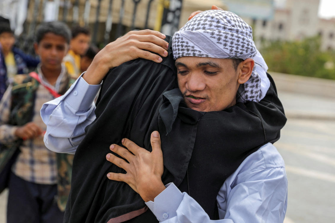 A released prisoner embraces his mother, as prisoners, who according to the Houthis are members of government forces, are released by the Houthis in Sanaa, Yemen May 26, 2024. (Reuters)