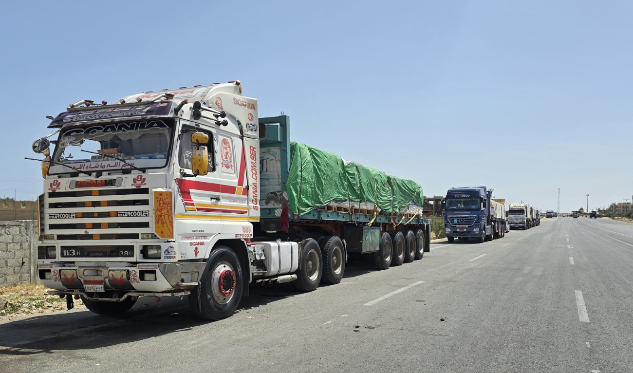 Egyptian trucks carrying humanitarian aid bound for the Gaza Strip wait near the Rafah border crossing on the Egyptian side on May 26, 2024. (AFP/File)