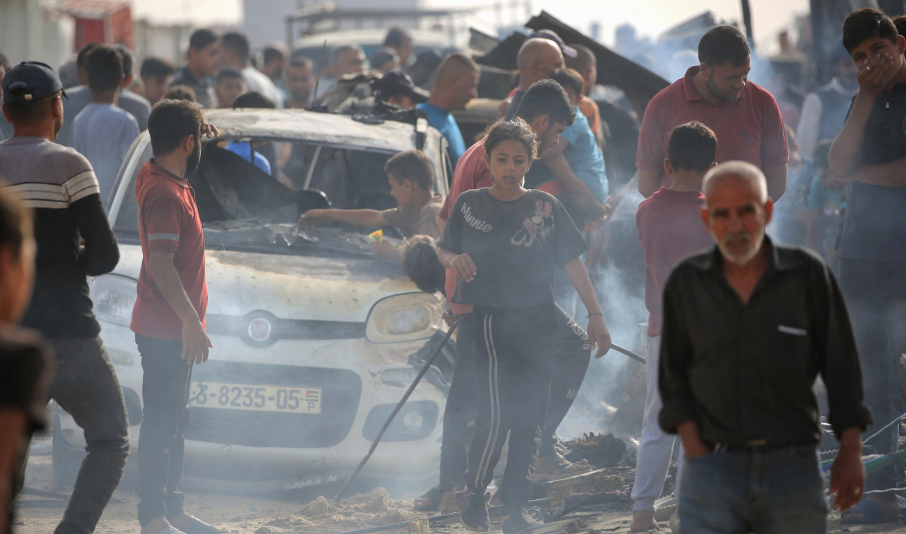 Palestinians gather at the site of an Israeli strike on a camp for internally displaced people in Rafah on May 27, 2024. (AFP)