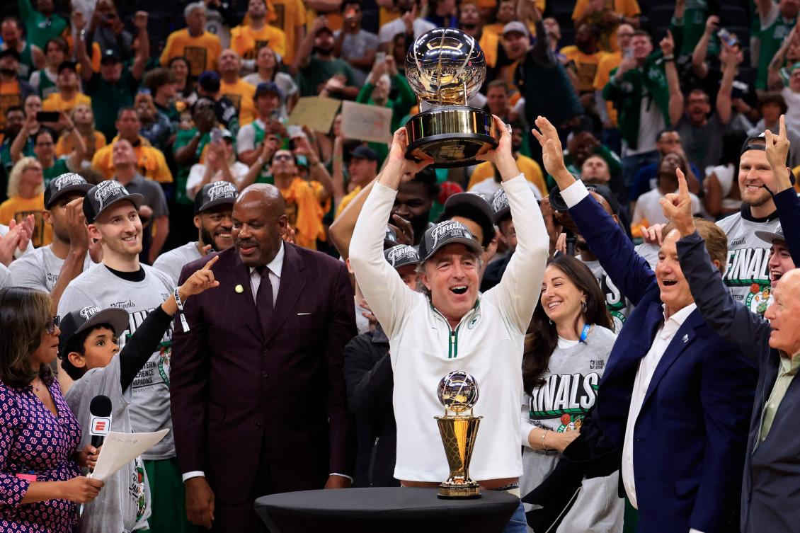 Boston Celtics owner Wyc Grousbeck hoists the Bob Cousy Trophy after sweeping the Indiana Pacers 4-0 of the Eastern Conference Finals on May 27, 2024. (Getty Images/AFP)