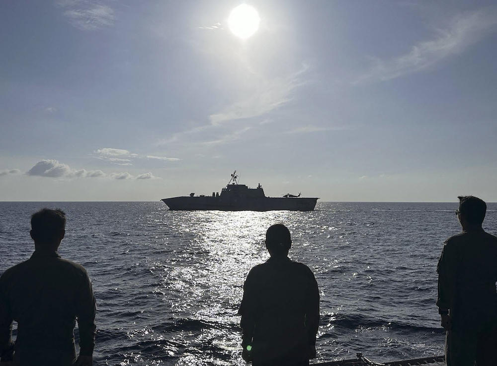 The USS Gabrielle Giffords, top, receives passing honors by Philippine Navy Officers aboard BRP Gregorio Del Pilar during the 3rd AFP-USINDOPACOM Maritime Cooperative Activity in the disputed South China Sea in February 2024. (AFP Western Command/AFP)