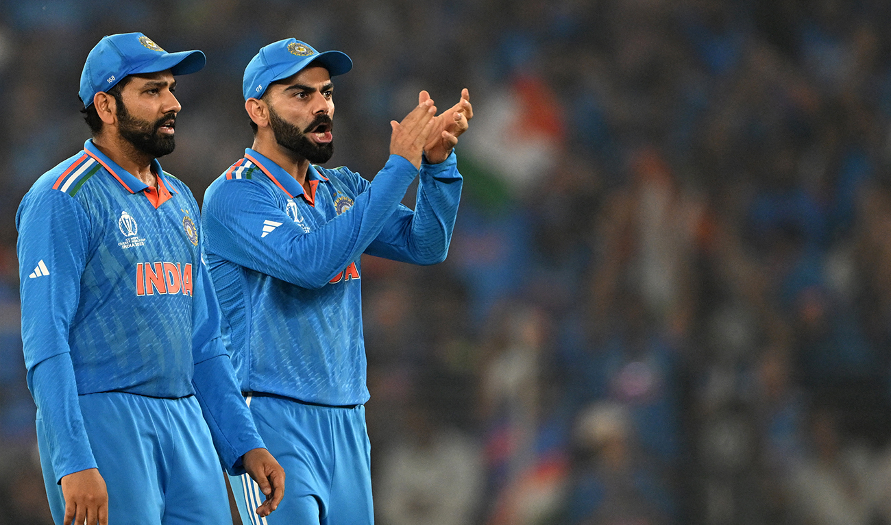India's captain Rohit Sharma (L) and teammate Virat Kohli celebrate after the dismissal of Australia's Mitchell Marsh during the 2023 ICC Men's Cricket World Cup one-day international (ODI) final match between India and Australia at the Narendra Modi Stadium in Ahmedabad on November 19, 2023. (AFP/File)