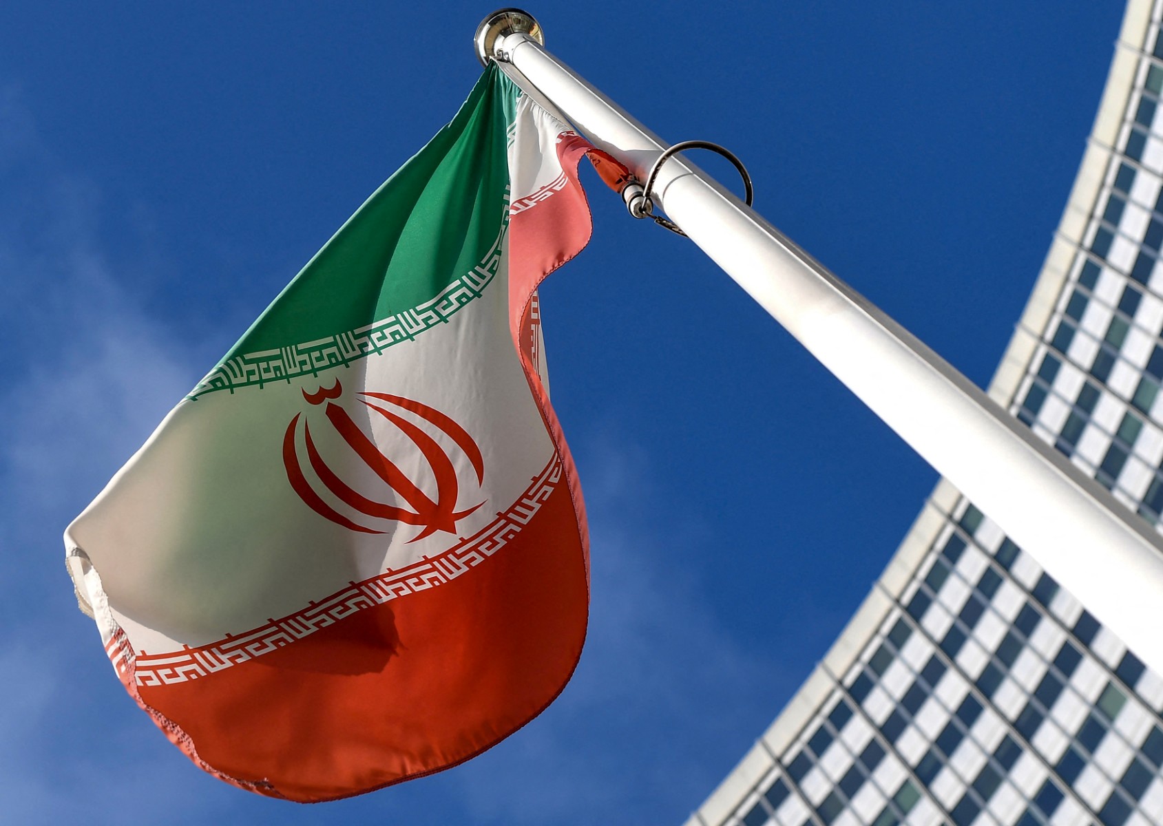 The Iranian national flag is seen outside the International Atomic Energy Agency (IAEA) headquarters during the agency's Board of Governors meeting in Vienna on March 1, 2021. (AFP)