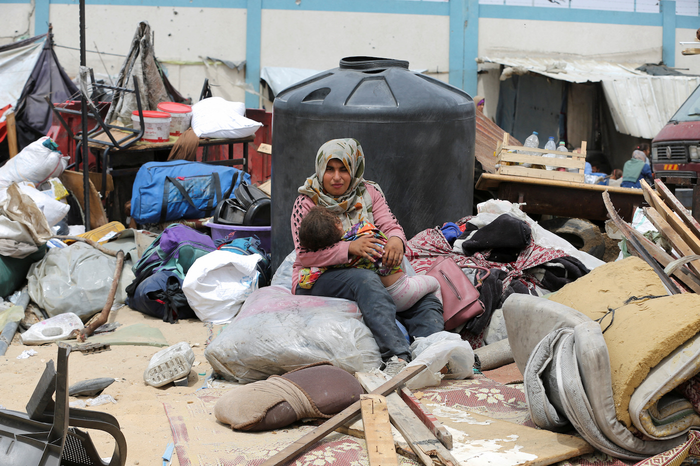 A woman sits with a child in Rafah, in the southern Gaza Strip, May 28, 2024. (Reuters)