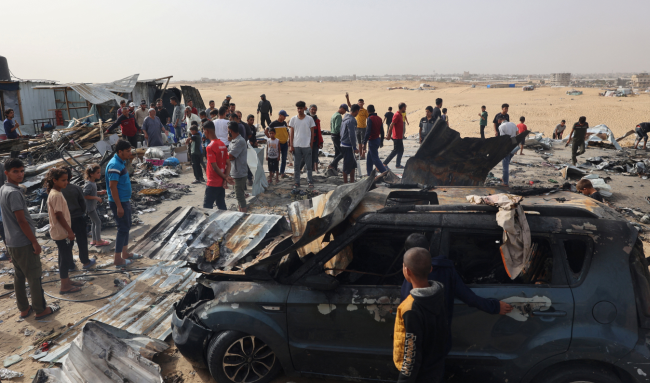 Palestinians gather at the site of an Israeli strike on a camp for internally displaced people in Rafah on May 27, 2024. (AFP)