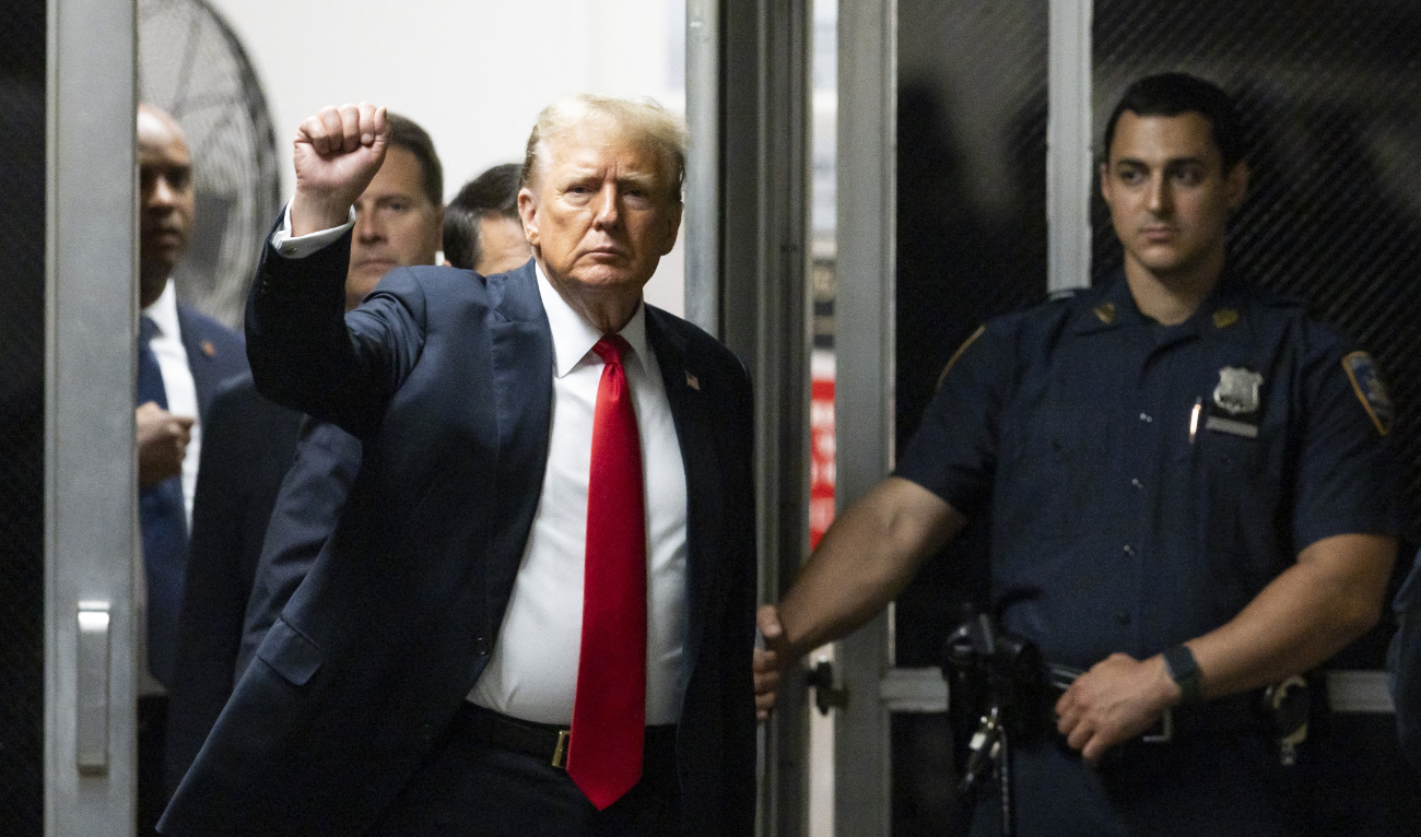 Former US President and Republican presidential candidate Donald Trump raises his fist as he returns from a break in his criminal trial at Manhattan Criminal Court in New York City, on May 28, 2024. (AFP)