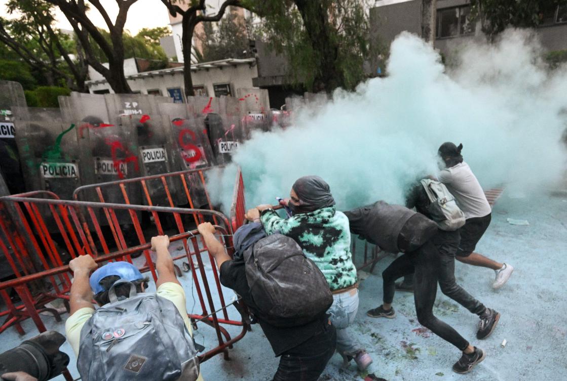 Demonstrators clash with police during a pro-Palestinian rally called "Urgent action for Rafah", held in front of the Israeli embassy in Mexico City. (AFP)