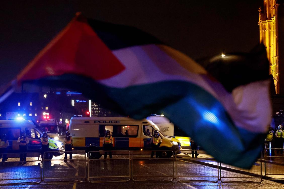A Palestinian flag flaps in the aire in front of Metropolitan Police (MET) officers arriving at a Pro-Palestinian “Hands off Rafah, End the genocide” rally in central London, on May 28, 2024, calling for a ceasefire in Gaza, following Israel’s attack in Rafah. Israel launched its controversial assault on Rafah earlier this month of May 2024, dismissing concerns for the safety of the 1.4 million Palestinian civilians then sheltering in the city.(AFP)