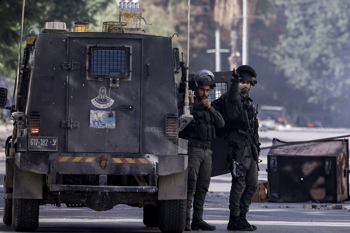 Israeli border police set up a checkpoint along a road east of Nablus in the occupied West Bank in this file photo during a raid on a suspected hideout of Palestinian militants. (AFP)