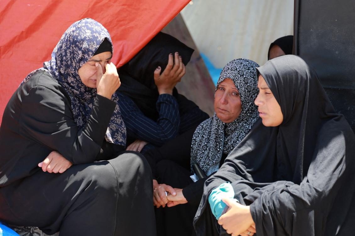 Palestinian women mourn relatives killed in Israeli bombardment as they sit by their displacement tent in Rafah in the southern Gaza Strip on May 29, 2024, amid the ongoing conflict between Israel and Palestinians. (AFP)