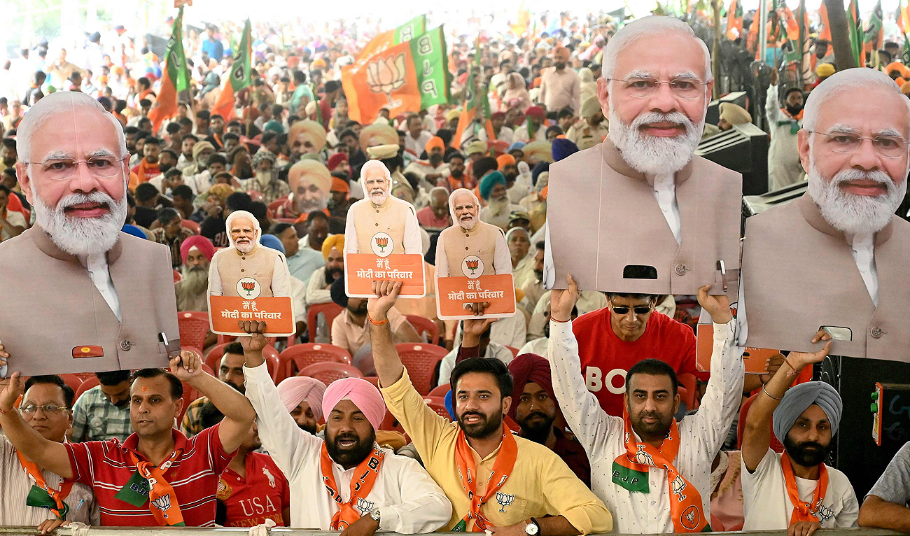 Supporters of the ruling Bharatiya Janta Party (BJP) holding cut-outs of India’s Prime Minister and their leader, Narendra Modi shout slogans during an election campaign rally of their president and election candidate Jagat Prakash Nadda (not pictured), in Amritsar on May 30, 2024 ahead of the seventh and final phase of voting in India’s general election. (AFP)